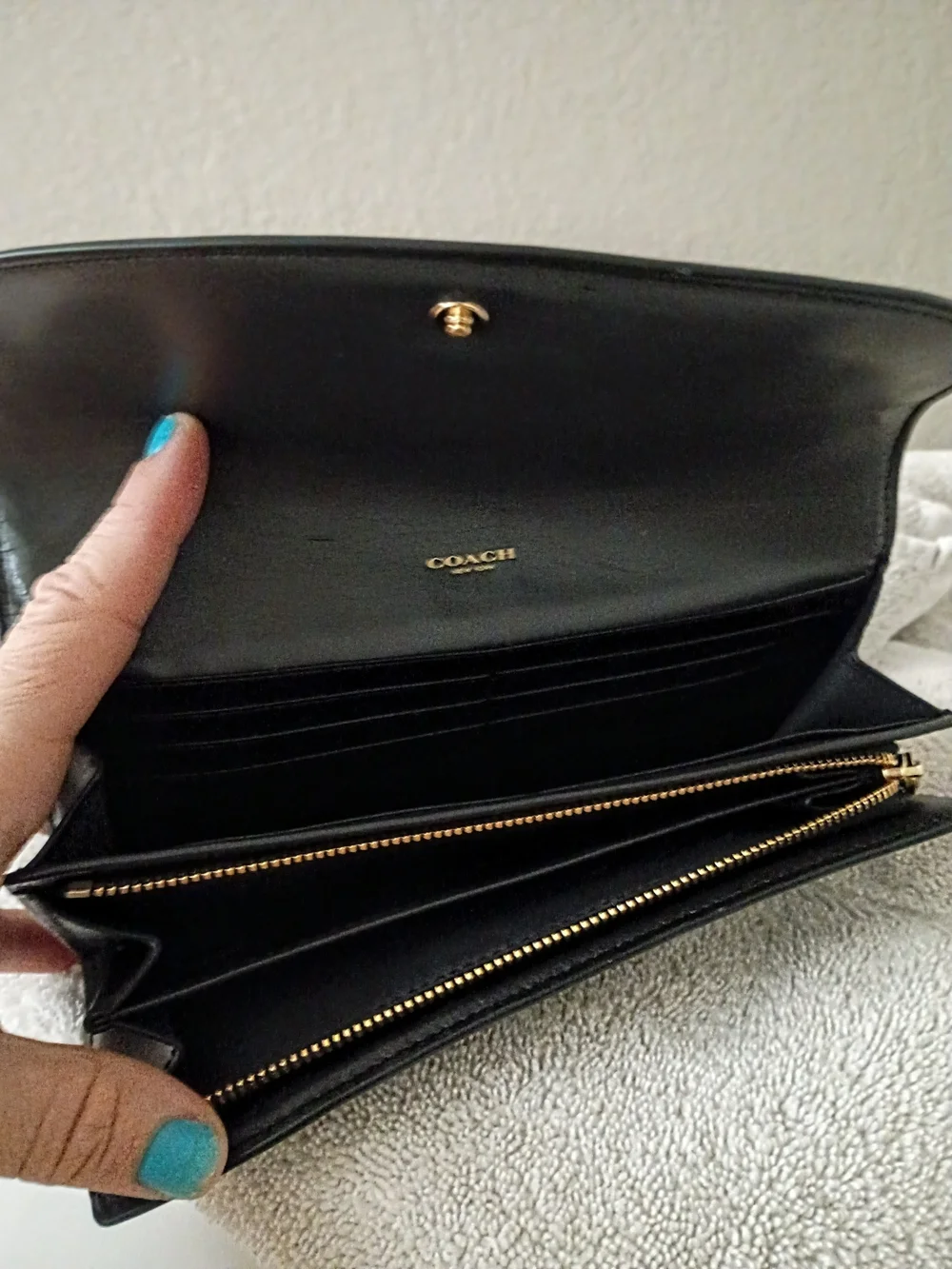 This Coach Signature PVC Slim Envelope Wallet features a brown monogram canvas b